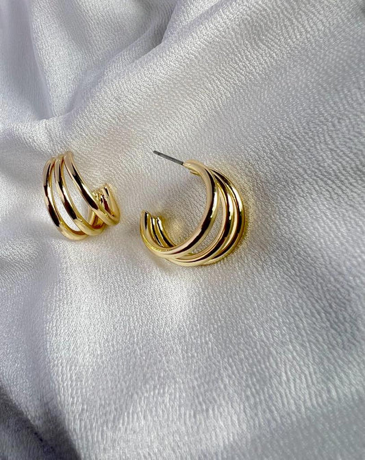 Gold triple hoop earring ÃƒÆ’Ã‚Â¢ÃƒÂ¢Ã¢â‚¬Å¡Ã‚Â¬ÃƒÂ¢Ã¢â€šÂ¬Ã…â€œ a stylish accessory featuring three interconnected gold hoops, creating an elegant and fashionable design.